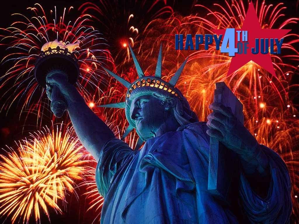 Statue of liberty with blue light and fireworks to celebrate the fourth of july